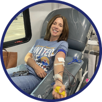 A Day of Caring volunteer donating blood