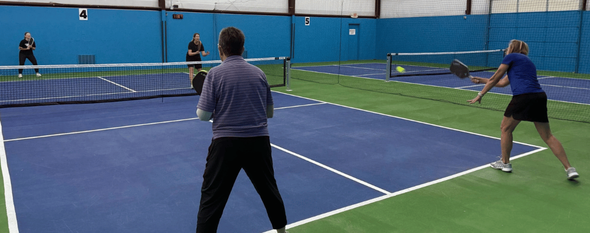 Participants playing a game of pickleball
