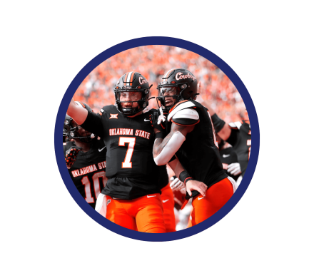 Two OSU football players celebrating at a game