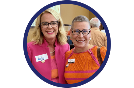 Two women wearing pink and orange