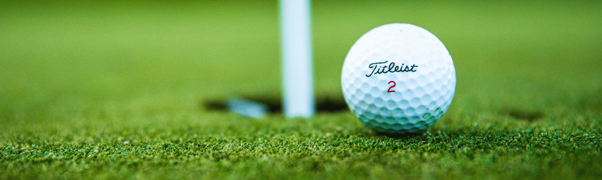 Golf ball sitting on putting green