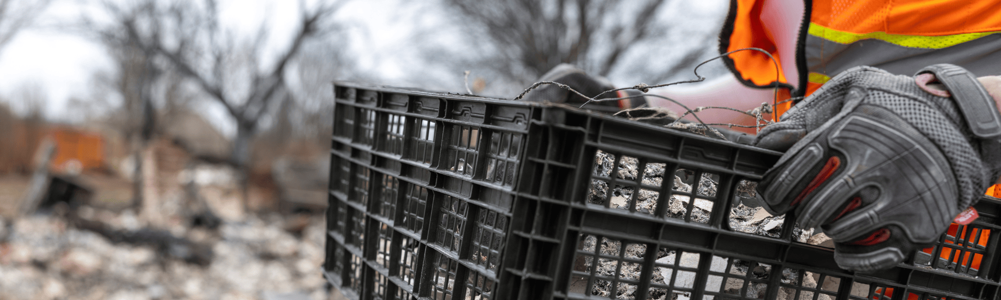 Person carrying box of fire-damaged items