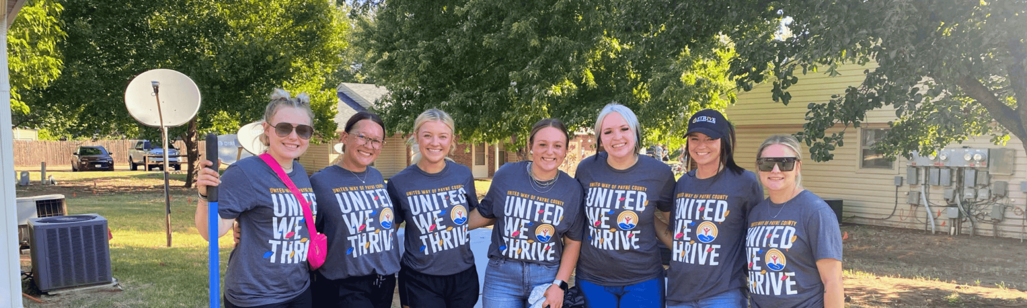 Seven girls wearing Day of Caring shirts