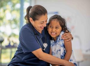 Doctor hugging a child