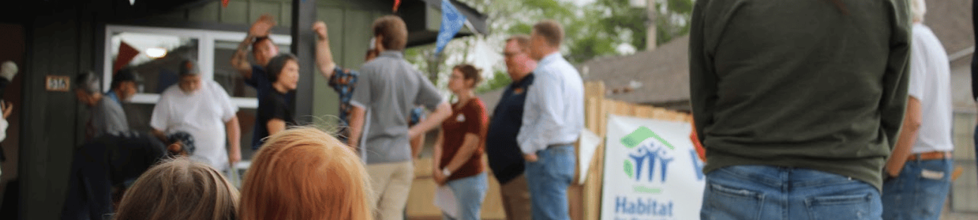 Attendees at a Habitat for Humanity house reveal