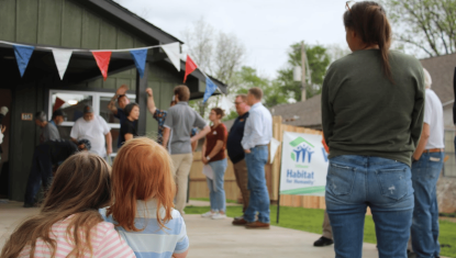Attendees at a Habitat for Humanity house reveal